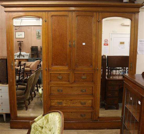 An Edwardian lemon wood triple wardrobe W.244cm